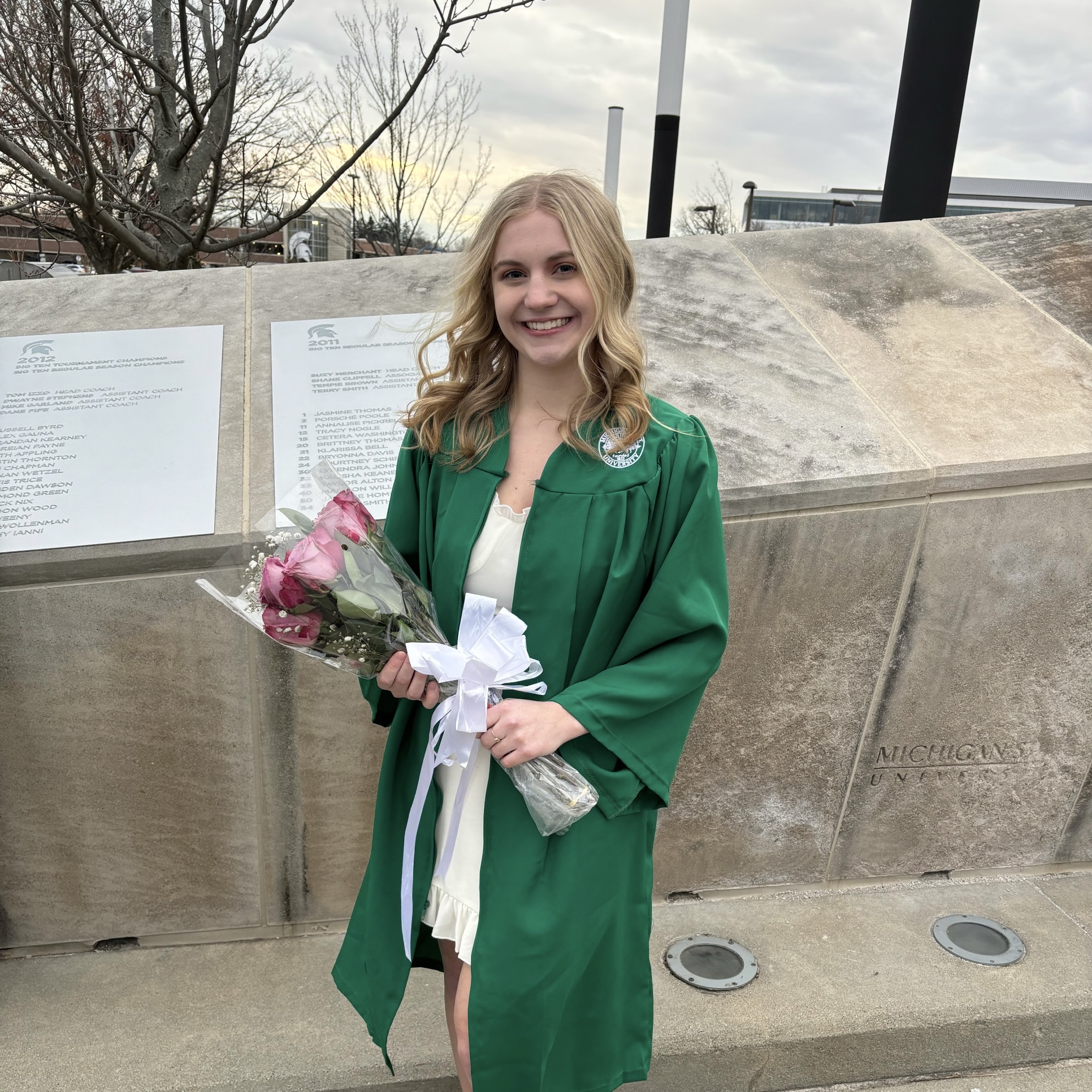 holding-grad-flowers